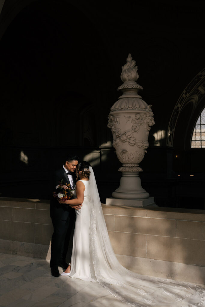 A wedding couple standing close together about to kiss 