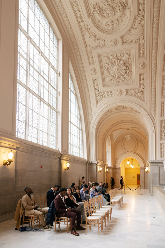 A group of people seated and waiting for a wedding to begin.