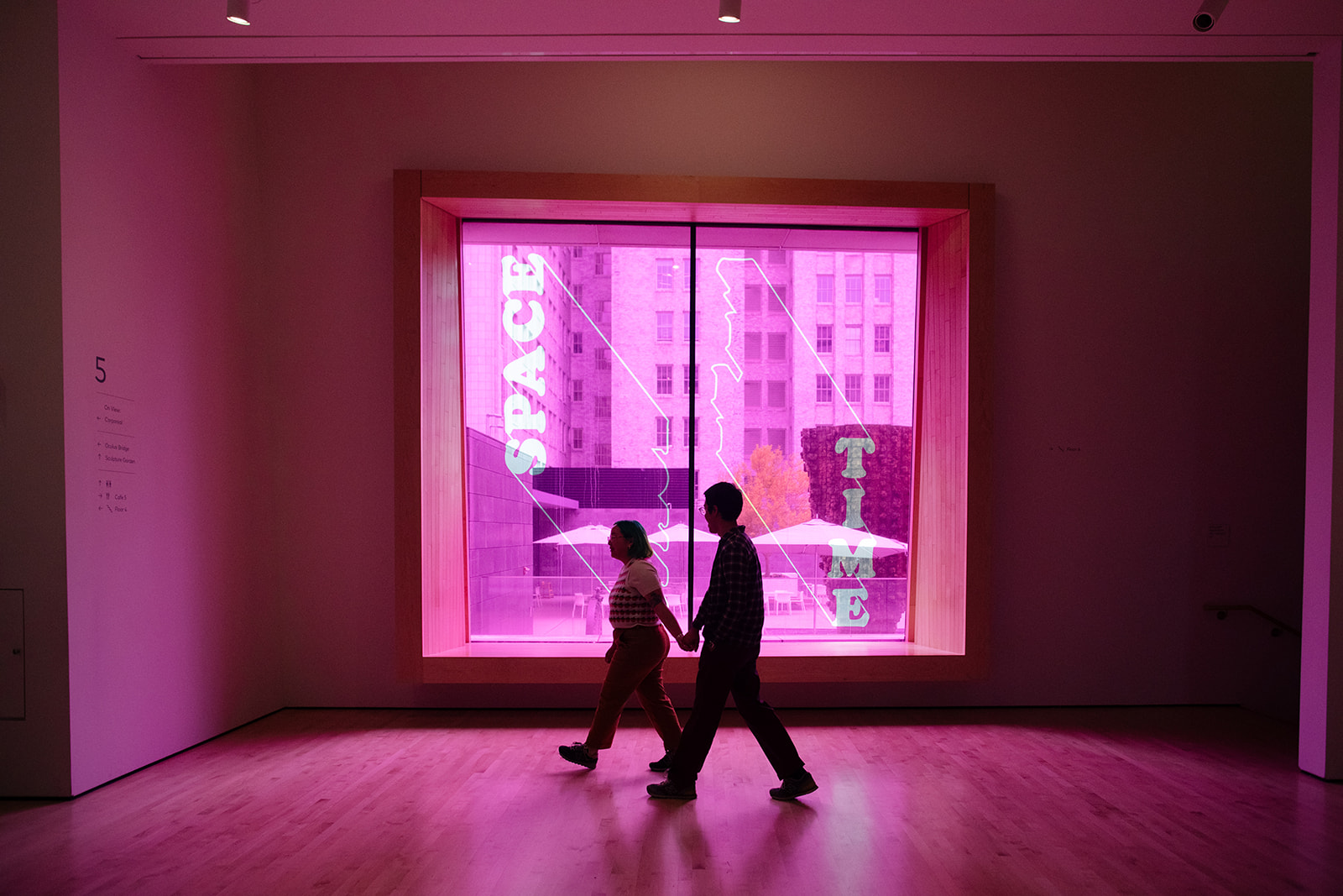 a couple taking engagement photos inside of MOMA  in san francisco 
