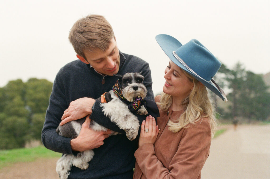 a couple holding their dog