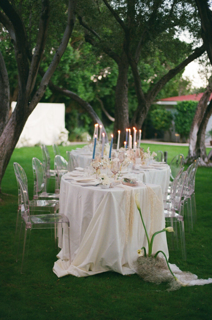 a wedding table set up with lit candles taken on film