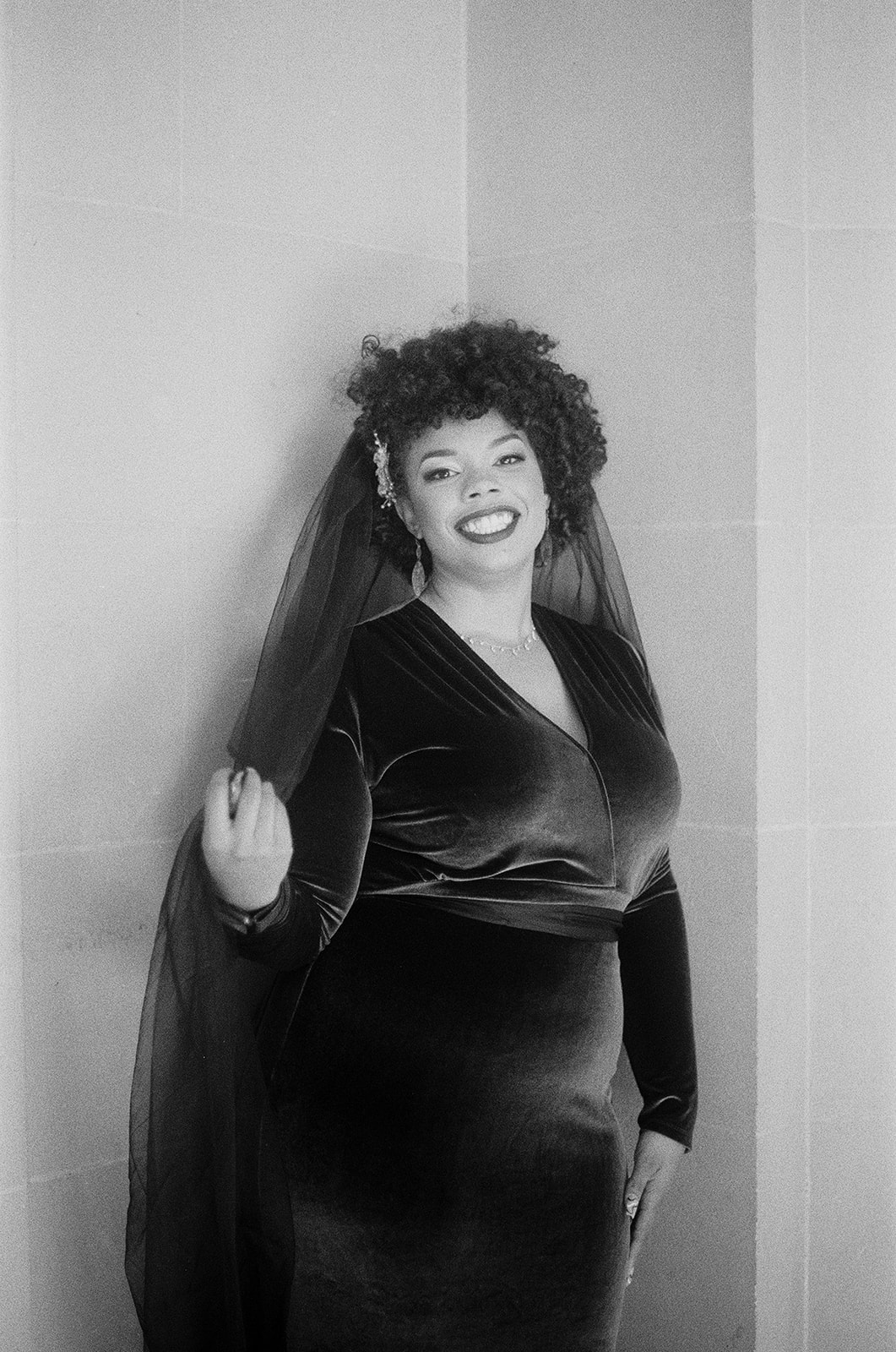 a woman wearing a green velvet dress and veil in san francisco city hall for her wedding captured on film 