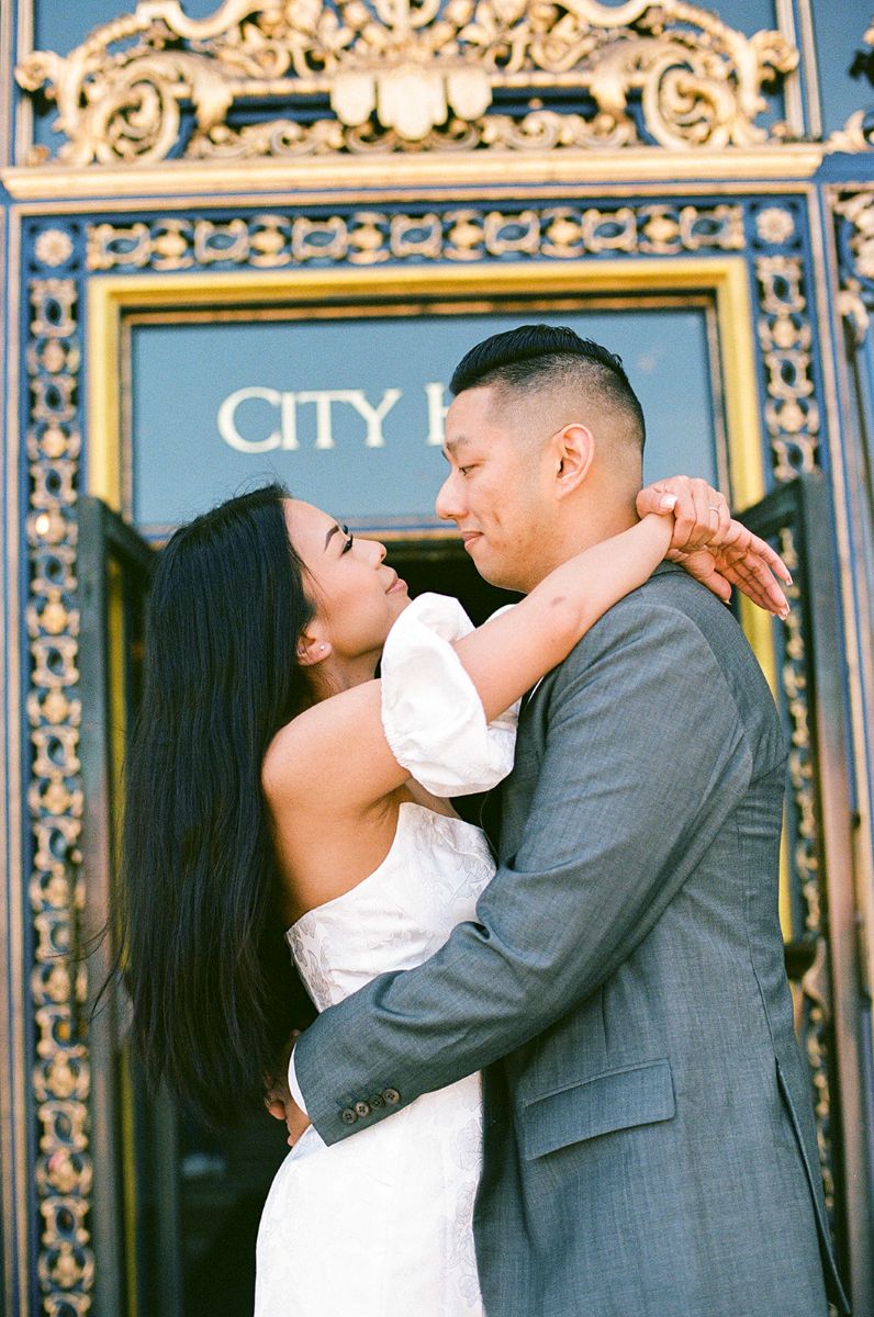 a couple celebrating their marriage in front of san francisco city captured on film 