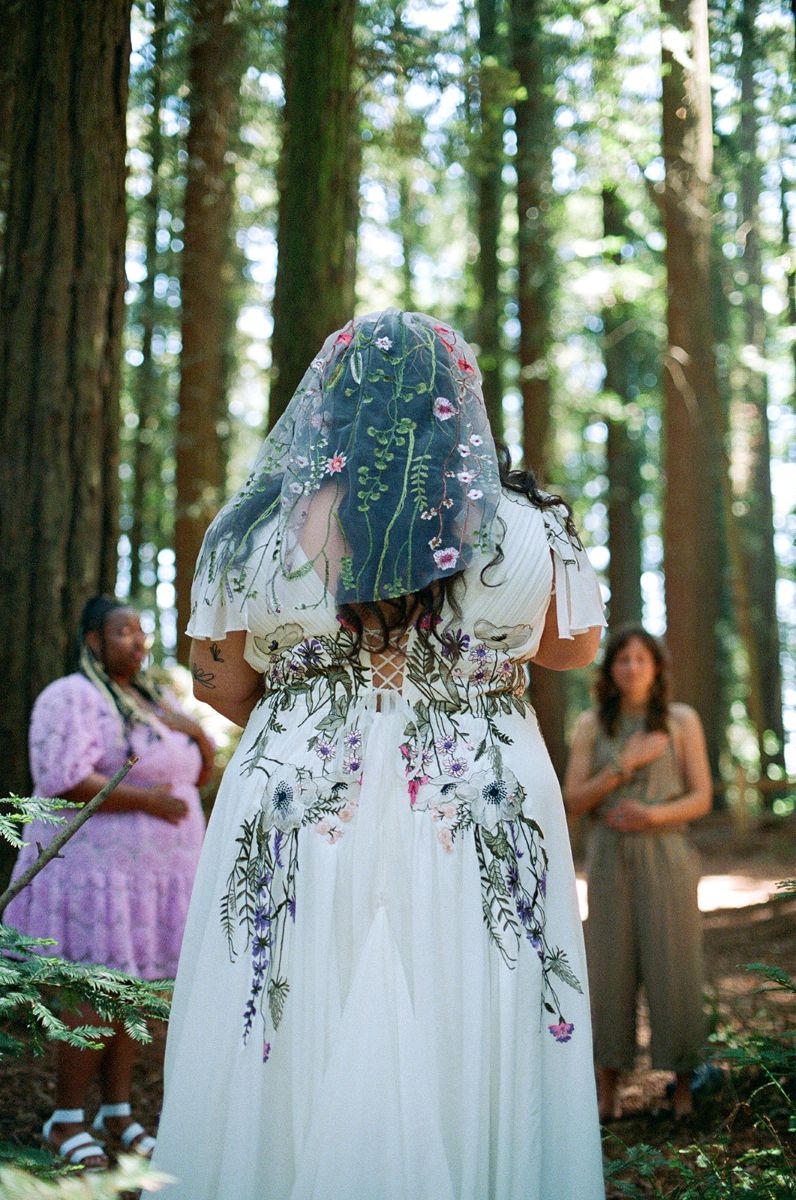a woman in a wedding dress walking to her wedding ceremony site 