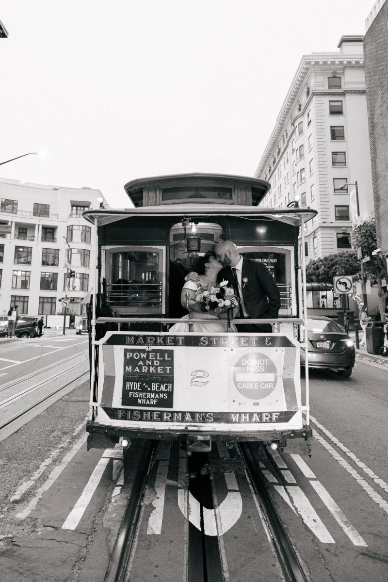 a couple kissing on a powell and market street tram in san francisco 