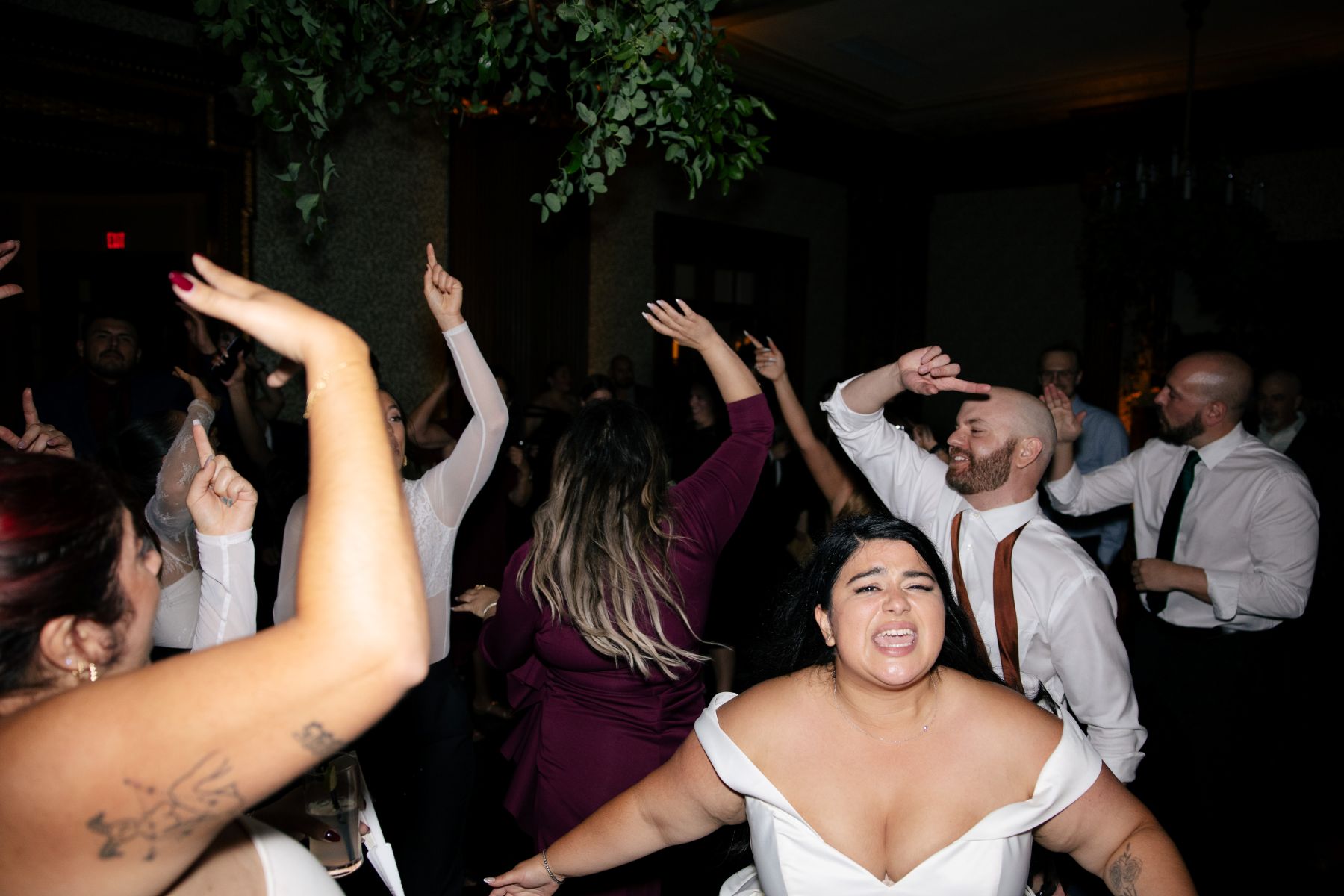 a copule dancing with their wedding guests at their wedding reception 