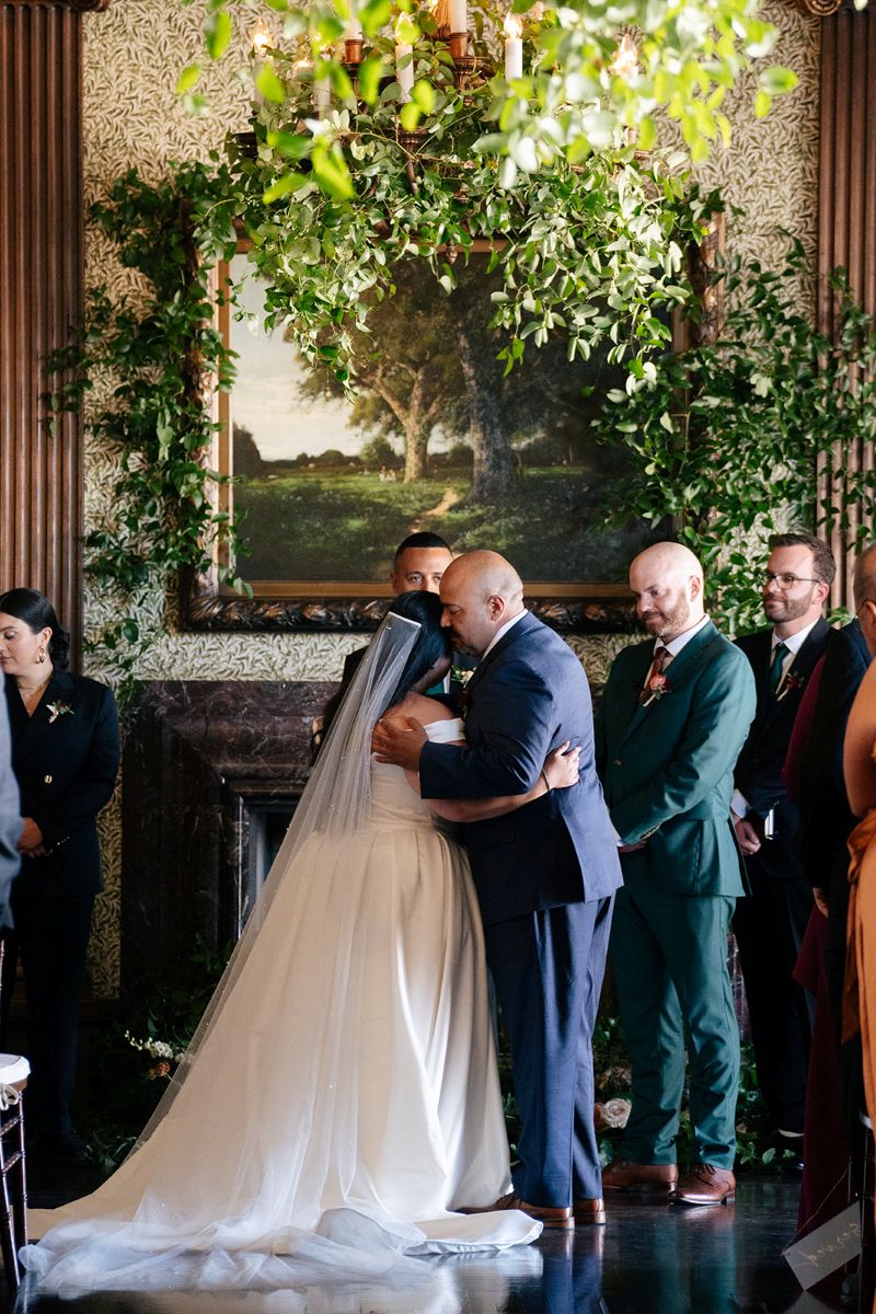 a couple hugging during their wedding ceremony at the University Club of San Francisco