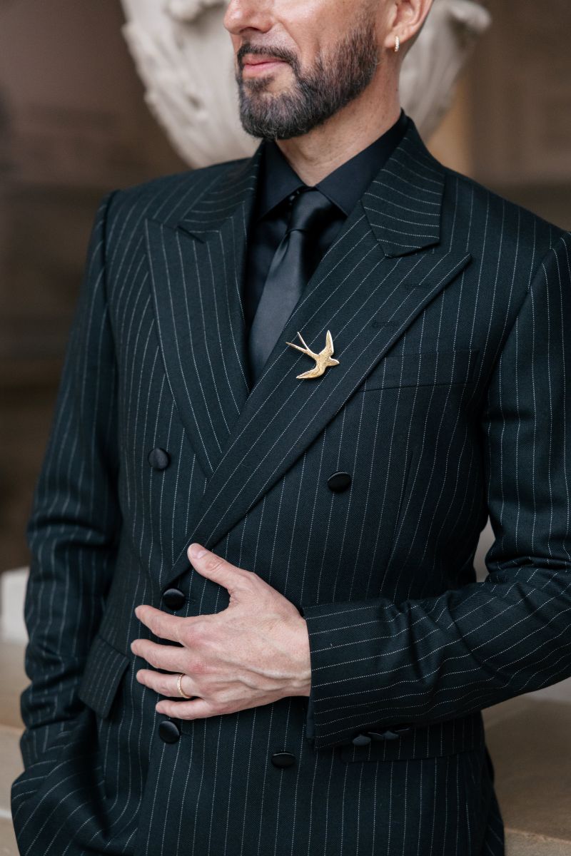 a man wearing a black suit in san francisco city hall