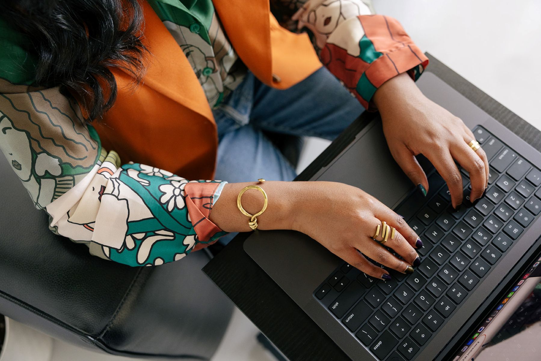the owner of ebb and flow nutrition and consulting sitting on a couch and typing on her laptop