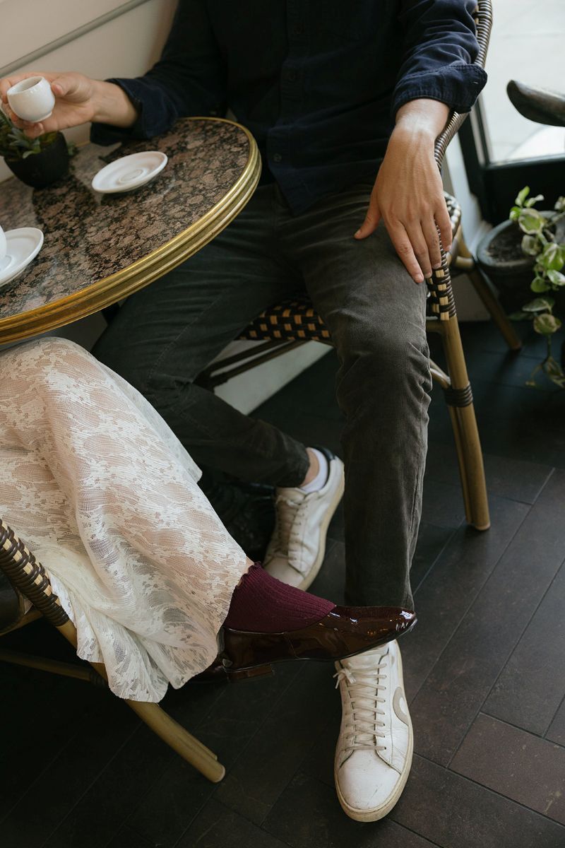 a couple sitting inside of a coffee shop together drinking espresso