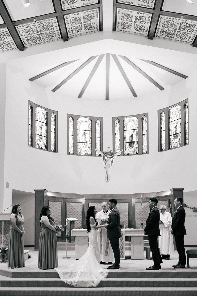 a couple having their wedding ceremony at Apollinaris Catholic Church 