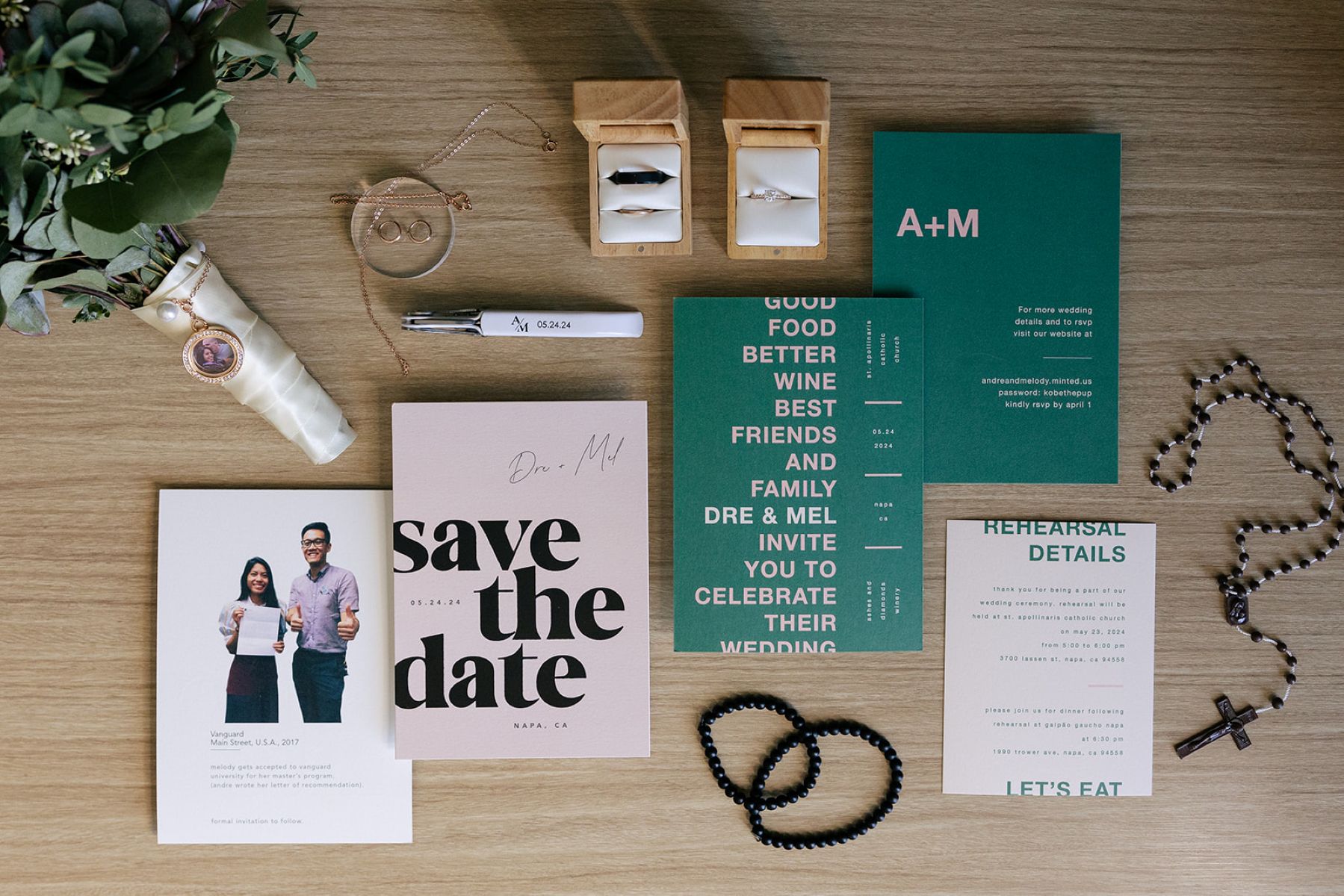 a wedding detail flat lay with wedding invitations, a rosary, a bouquet, and wedding rings 