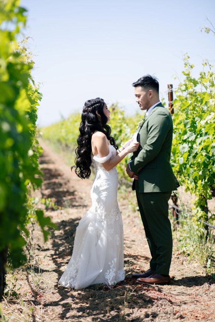 a couple reading private vows to each other in the vineyard of ashes and diamonds winery 