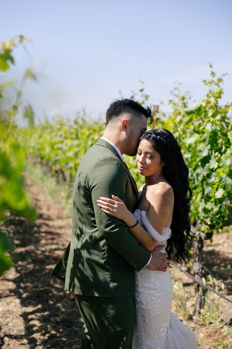 a couple taking wedding portraits in the ashes and diamonds vineyard in napa valley 
