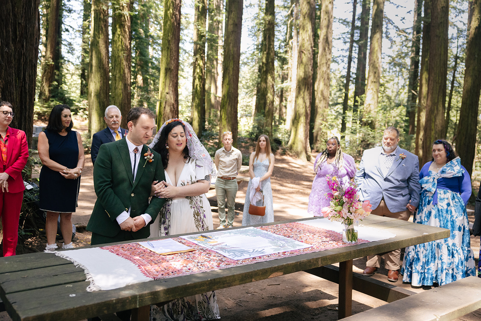 a couple performing a traditional jewish wedding ritual with their families in roberts regional park 