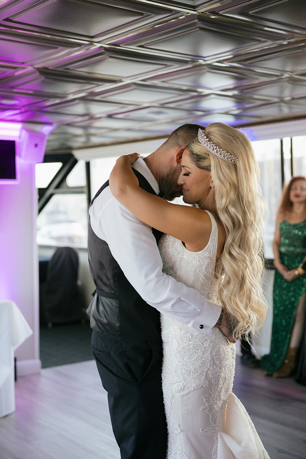a couple sharing their first dance inside of a yacht on the san francisco bay 