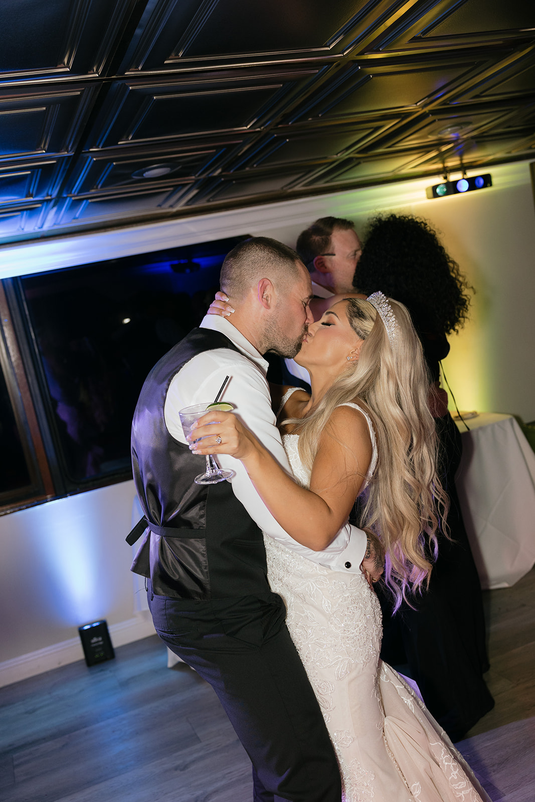 a couple kissing during their wedding reception on a yacht 
