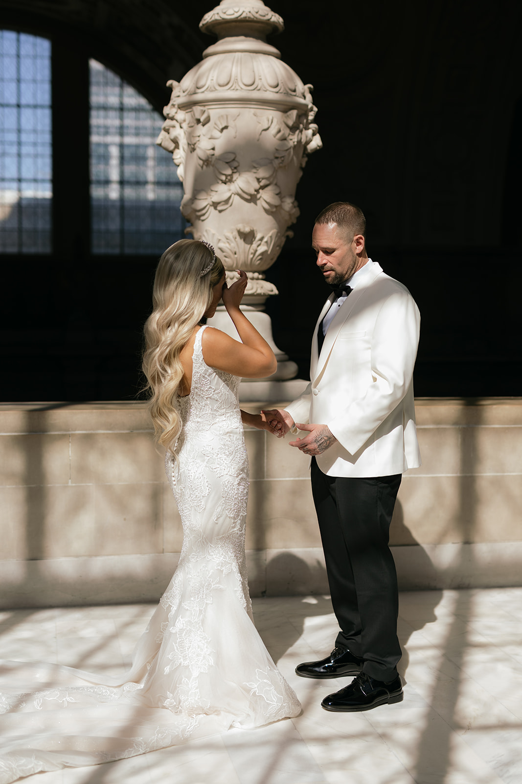 a couple sharing a first look on the mayor's balcony inside san francisco city hall 